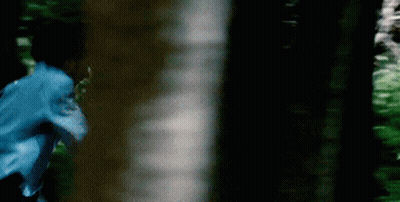Blurry Person Running Through Forest GIF