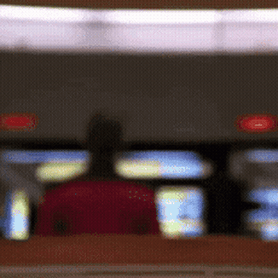 Blurry Person Sitting In Red Chair GIF