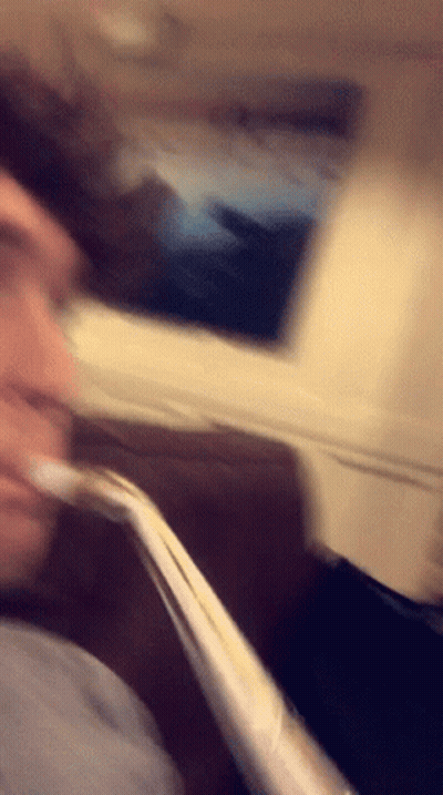 Blurry Person Sitting on Couch With Straw