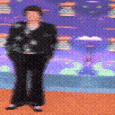 Blurry Person Standing Against Colorful Background GIF