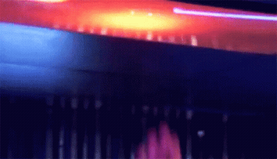 Blurry Person Standing In Dark Room With Purple Light GIF