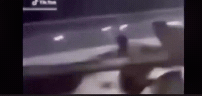 Blurry Person Standing In Front Of Car GIF