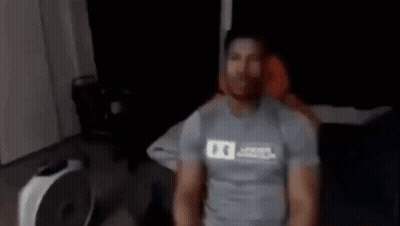 Blurry Person Standing Next To Fan GIF