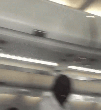 Blurry Person Standing Under Ceiling GIF