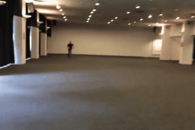 Blurry Person Walking In Large Room GIF