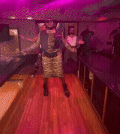 Blurry Photo Group Dancing Under Purple Lights GIF