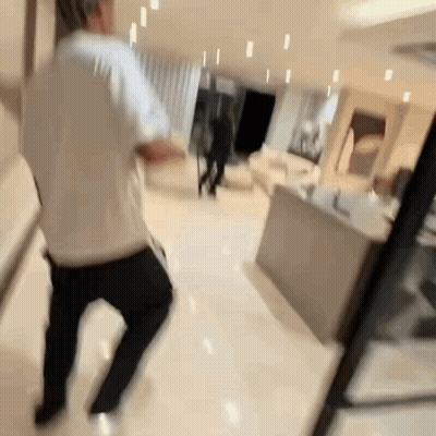 Blurry Photo Of Man Dancing In Living Room GIF
