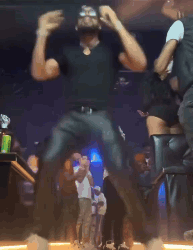 Blurry Photo Of Man Dancing With Arms Outstretched GIF