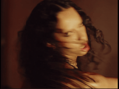 Blurry Photo of Woman With Long Curly Hair