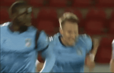 Blurry Soccer Player In Blue Jersey Celebrating GIF