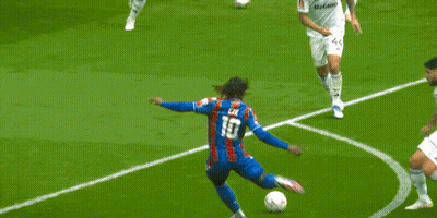 Blurry Soccer Player Kicking Ball Into Goal GIF