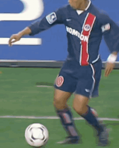 Blurry Soccer Player Kicking Soccer Ball GIF