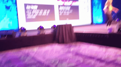 Blurry Stage With Purple Carpet And Large A Screen GIF