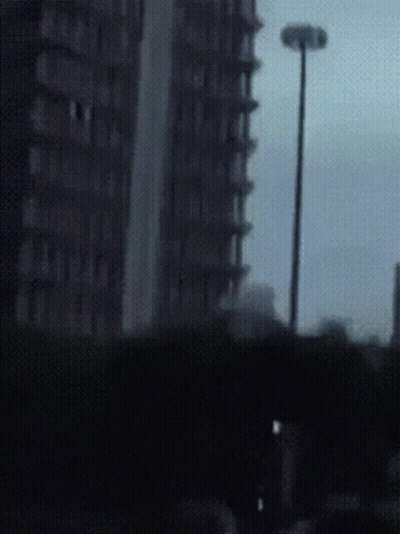 Blurry Street Light And Tall Building GIF