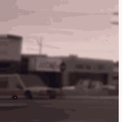 Blurry Street With Cars And Buildings GIF