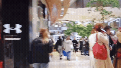 Blurry Under Armour Store With People Walking GIF