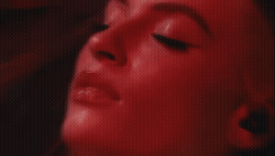 Blurry Woman Face With Red Light Behind GIF