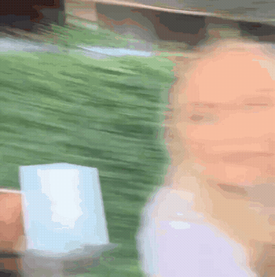 Blurry Woman Holding Cup GIF