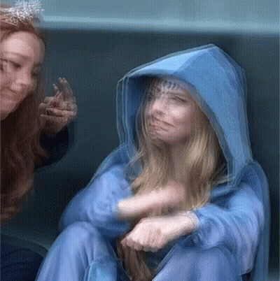 Blurry Woman In Blue Hooded Jacket GIF