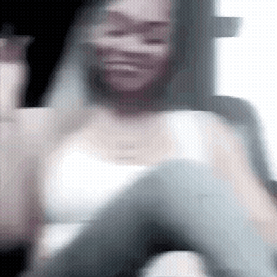 Blurry Woman In White Tank Top Sitting In Car GIF