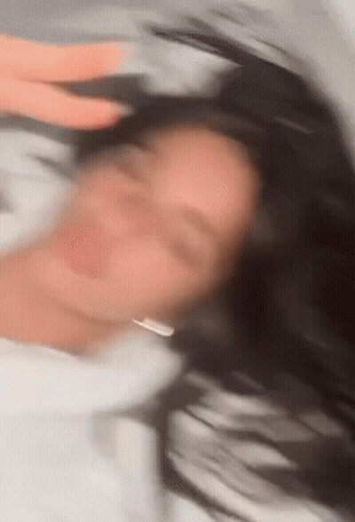 Blurry Woman Laying On Bed With Eyes Closed GIF