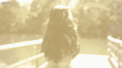 Blurry Woman On Bridge Saying Bench GIF