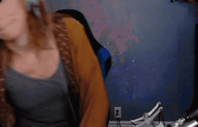 Blurry Woman Sitting In Front Of Purple Lights GIF