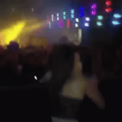 Blurry Woman Standing In Front Of Crowd GIF
