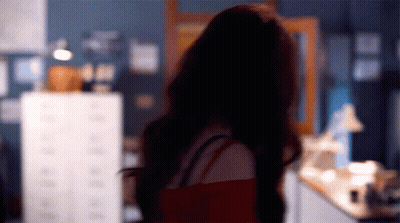Blurry Woman Standing With Back To Camera GIF