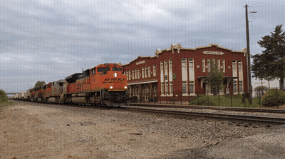 BNSF Train Pulling Up To Railroad Station GIF