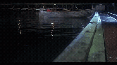 Boat With Red Oar Floating On Water GIF