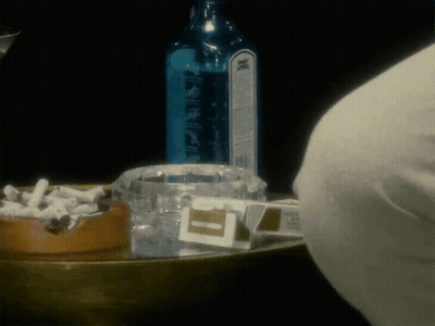 Bombay Sapphire Bottle Next To Ashtray Full Of Cigarettes GIF