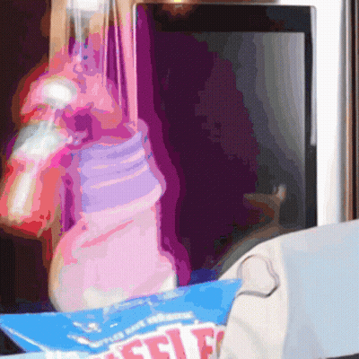 Bottle Hanging From Rope Next To Box Saying Selfie GIF