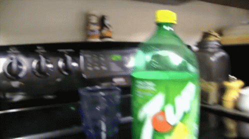 Bottle Of 7 Up On Stove Top GIF