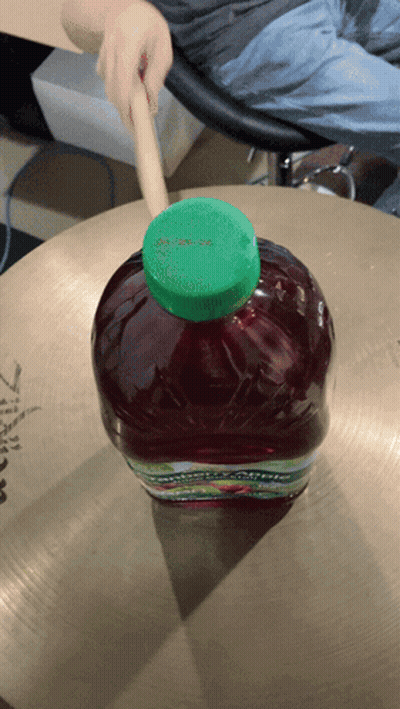 Bottle Of Apple Juice On Cymbal GIF