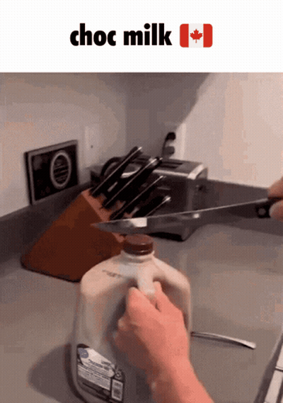 Bottle Of Choc Milk Cut With Knife GIF