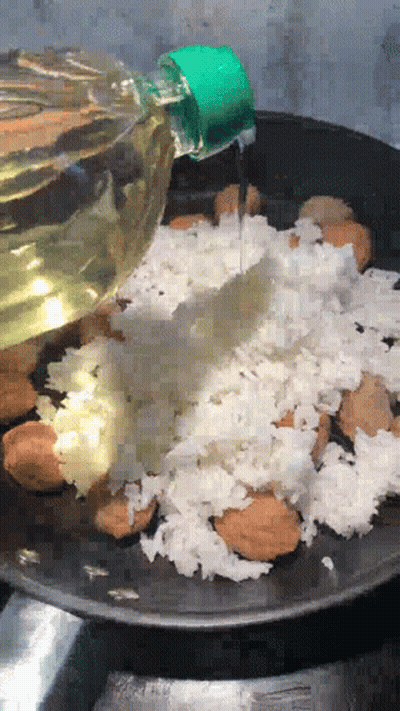 Bottle Of Oil Poured Over Rice GIF