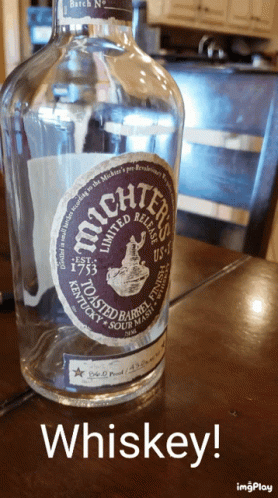 Bottle Of Whiskey Next To Chair GIF