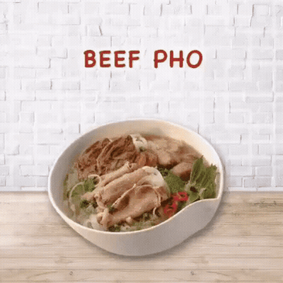 Bowl of Beef Pho on Wooden Table