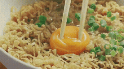 Bowl Of Noodles With Broken Egg And Chopsticks GIF