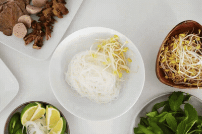 Bowl Of Noodles With Sprouts And Limes GIF