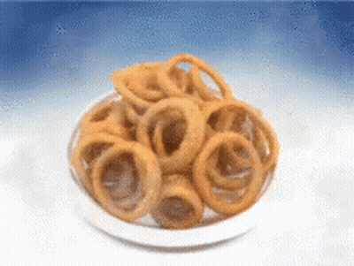 Bowl Of Onion Rings On Blue Background GIF