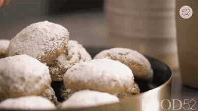 Bowl Of Powdered Sugar Cookies With Number 52 GIF