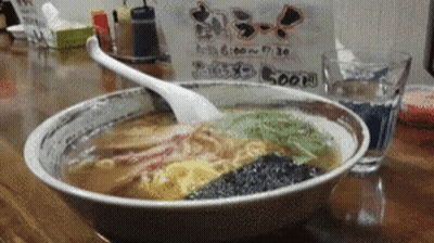 Bowl Of Ramen With Spoon On Wooden Table GIF