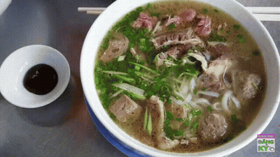 Bowl Of Soup With Chopsticks And Dipping Sauce Saying Kyo GIF