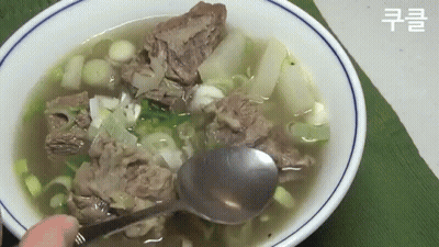 Bowl Of Soup With Meat And Vegetables Being Eaten With Spoon GIF
