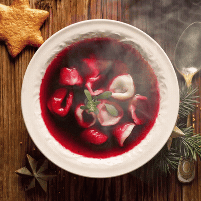 Bowl Of Soup With Spoon And Star Cookie On Wooden Table GIF