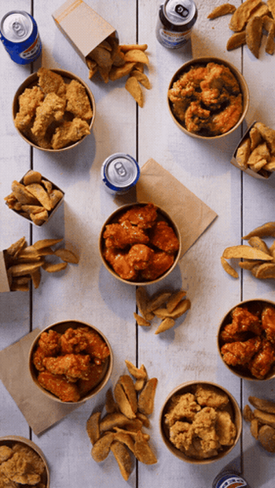 Bowls Of Fried Chicken And French Fries On A Table With A Can Of Pepsi GIF