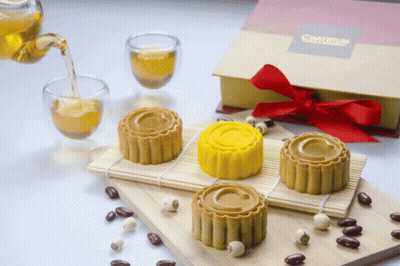 Box With Red Bow Next To Cakes GIF
