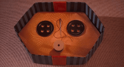 Box With Two Yellow Buttons And Needle GIF